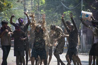 Revellers palying mud to celebrate Holi