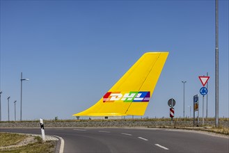 Tail fin of an aircraft in a roundabout of the DHL Air Hub