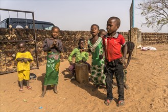 A group of African children with self-made drums singing and playing
