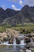 Waterfall of the Fairy Pools in front of the Black Cuillin in Glen Brittle on the Isle of Skye