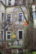 Graffiti nature landscape on an unrenovated apartment building
