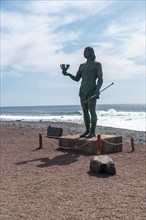 Statue of Hautacuperche on the beach of the town of Valle Gran Rey in La Gomera