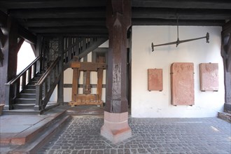 Ground floor of the historic town hall with cloth press and stone wall panels