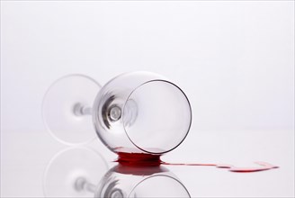 Red wine spilled out of fallen glass
