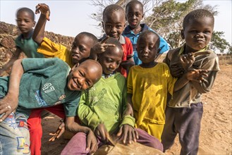 A group of African children with self-made drums singing and playing
