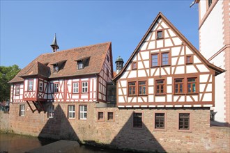 Historic town hall and half-timbered house with bay window on the Muemling stream