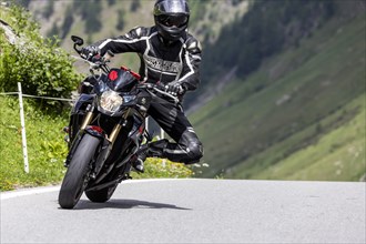 Motorbike on the winding Nufenen Pass in the Alps