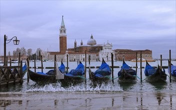 Moored gondolas at the Bacino di San Marco with the church of San Giorgio Maggiore