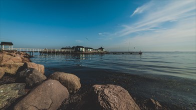 Seaside with pier and rocks