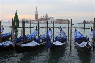 Hoarfrost on the gondolas at the piazzetta in front of the monastery and island of San Giorgio Maggiore