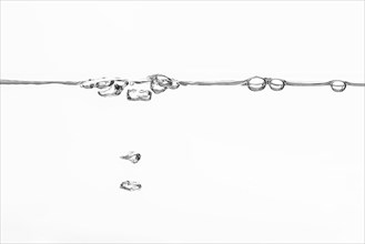 Sweeping water surface with waves and swirls on a white background artistic depiction of air bubbles breaking through a water surface