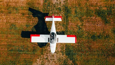 Red and white aircraft from above. Type Breezer B400-6
