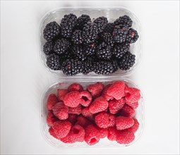 Blackberry and raspberry fruit in boxes