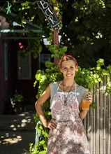 Smiling entrepreneur outisde her juice shop. Copy space