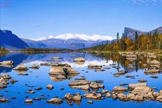 Scenic view at Lake Laitaure in rapa valley at Sareks national park with and snow capped mountains and autumn colors
