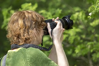 Woman photographing butterfly