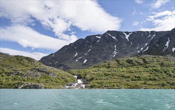 Lake Gjende with mountains and waterfall