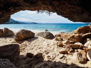 Karst cave on the sandy beach near the campsite of Stara Baska