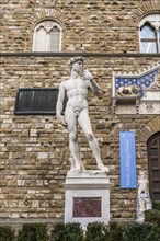 Replica reproduction statue of Michelangelo's David at the entrance of the Palazzo Vecchio in Florence