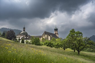 Thunderclouds pass over the Muenstertal and the monastery of Sankt Trudpert