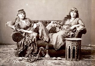 Two Women in Turkish Costume Sitting on a Sofa
