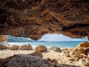 Karst cave on the sandy beach near the campsite of Stara Baska