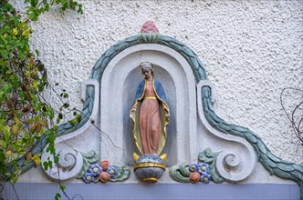 Madonna figure on a historical building in the old town