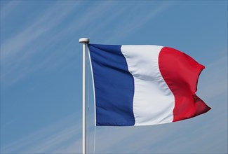 French Flag of France over blue sky
