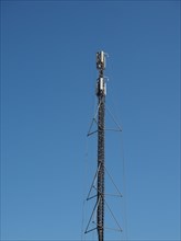 Aerial antenna tower over blue sky