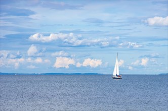 Lonely sailing boat in the distance in the Greifswalder Bodden