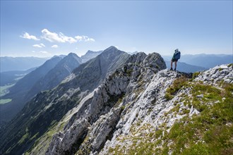 Mountaineer at the summit of the Upper Wettersteinspitze