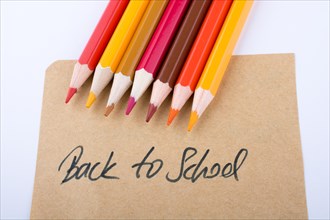 Color pencils and back to school title on a notebook