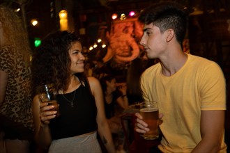 Young people flirting. Blurred background. Couple meet at a bar for a first date