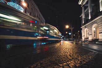 Tram on the night street of the city