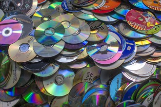 Old CD's collected for recycling in a container