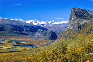 Landscape view with autumn colors and and snow capped mountains in Rapa valley in Sarek national park in Sweden