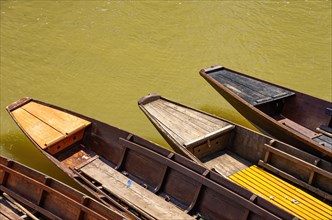 Tips of wooden barges in the water