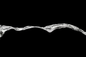Released sweeping water surface with waves and eddies on a black background