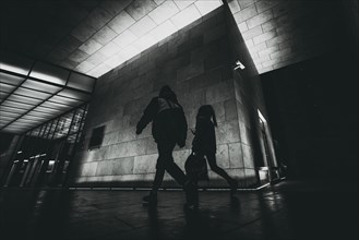 Silhouette of people on night city street