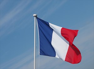 French Flag of France over blue sky