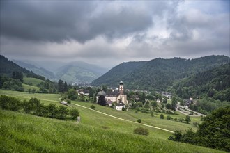 Thunderclouds pass over the Muenstertal and the monastery of Sankt Trudpert