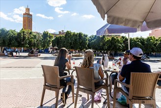 People sitting at cafe in main square