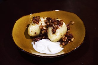Cepelinai dumplings with roasted bacon and sour cream