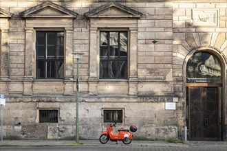 An e-scooter from Emmy stands in front of an old building in Berlin