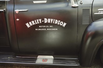 Advertisement for Harley Davidson on the car door of a 1953 Ford F100 V8