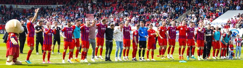 The 1.FC Heidenheim team celebrates together with the fans