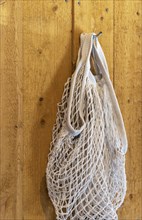 Traditional shopping net hanging on a wooden wall