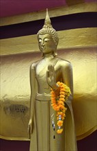 Standing Buddha figure with blessing hand posture