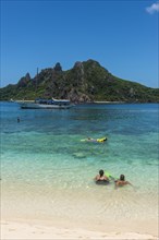 Tourists enjoying the beautiful clear turquoise waters of Monuriki or Cast away island