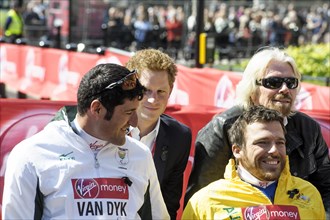 Prince Harry presents a medal to the Mens Elite Wheelchair winner Kurt Fearnley at the Virgin London Marathon Medal Presentations on 21.04.2013 at The Mall